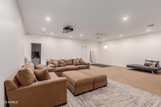 living area with recessed lighting, light carpet, visible vents, and baseboards