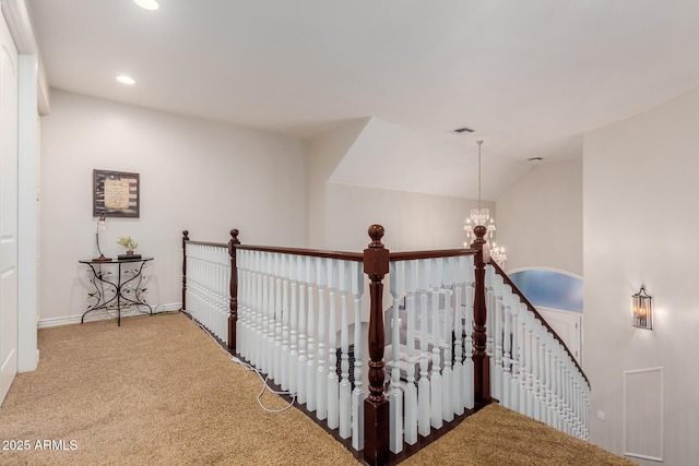 hall featuring carpet, recessed lighting, visible vents, an upstairs landing, and a chandelier