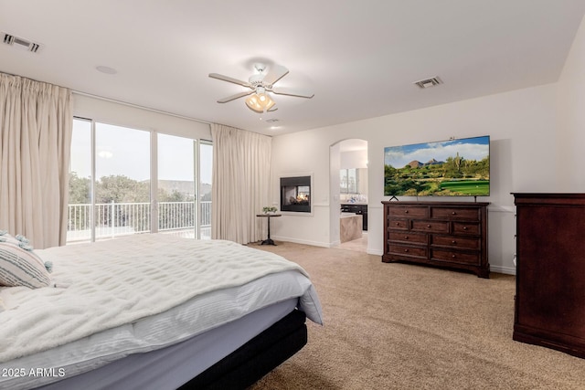 bedroom with light carpet, access to outside, visible vents, and baseboards