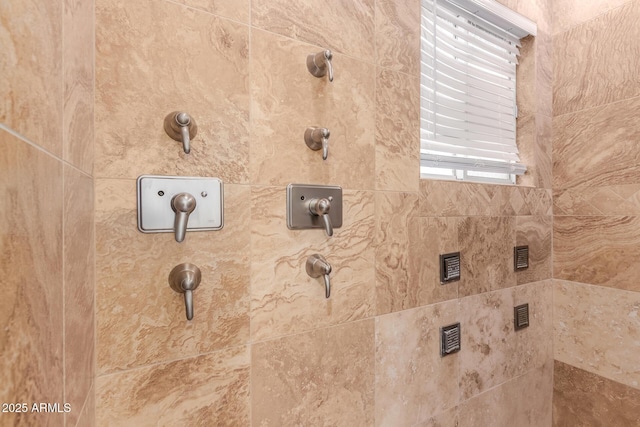 interior details featuring a tile shower