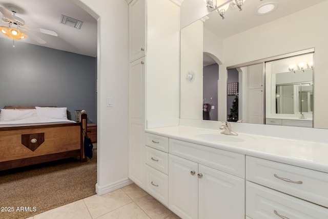 ensuite bathroom featuring ceiling fan, vanity, visible vents, tile patterned floors, and ensuite bath