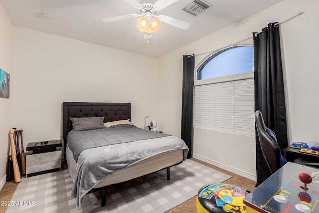 bedroom with a ceiling fan, visible vents, light carpet, and baseboards