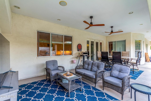 view of patio featuring a ceiling fan, french doors, and an outdoor living space