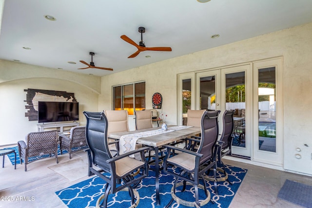 view of patio featuring ceiling fan, french doors, and outdoor dining space