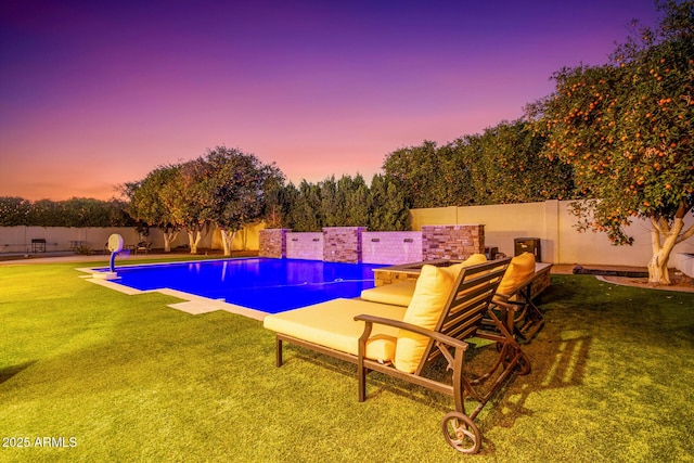 view of swimming pool with a fenced in pool, a fenced backyard, and a lawn