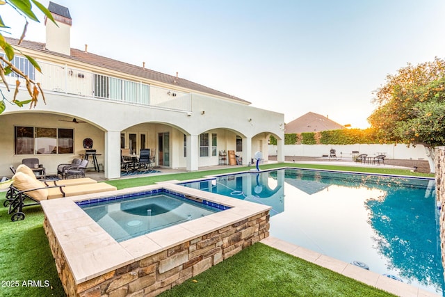 view of pool featuring a fenced in pool, a ceiling fan, a patio area, fence, and an in ground hot tub