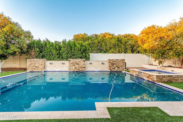 view of pool with a fenced in pool, a fenced backyard, and an in ground hot tub