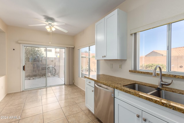 kitchen featuring dishwasher, white cabinetry, plenty of natural light, and dark stone countertops