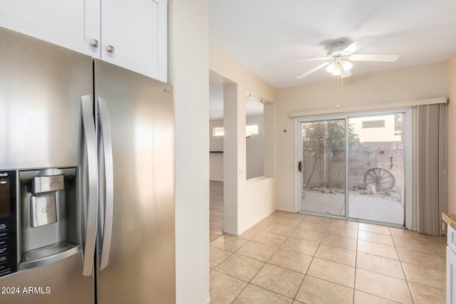 kitchen featuring white cabinets, stainless steel fridge, ceiling fan, and light tile patterned flooring