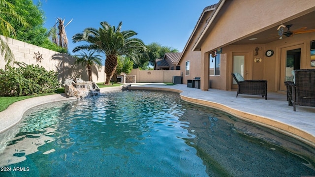 view of pool featuring pool water feature, ceiling fan, and a patio area