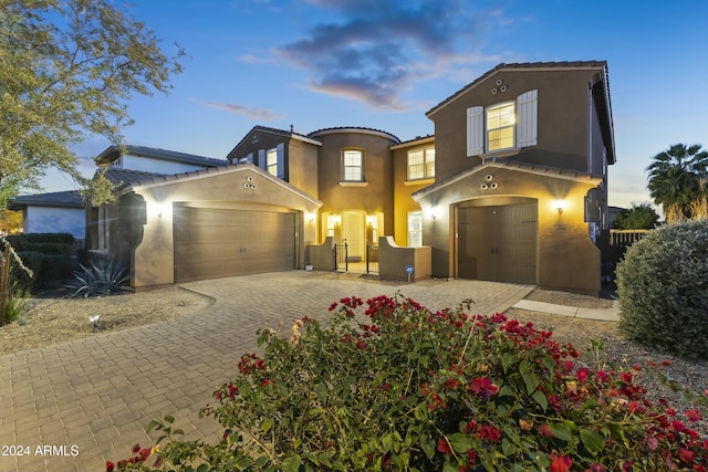 14575 W Orange Dr, Litchfield Park, AZ 85340 - mediterranean / spanish home with stucco siding, decorative driveway, and a garage