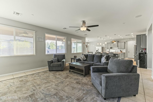 living room with ceiling fan and light tile patterned floors