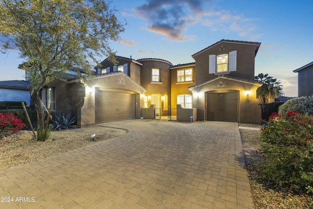 14575 W Orange Dr, Litchfield Park, AZ 85340 - mediterranean / spanish-style house with stucco siding, decorative driveway, and a garage