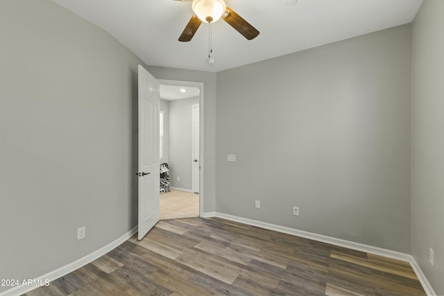 unfurnished room featuring ceiling fan and hardwood / wood-style floors