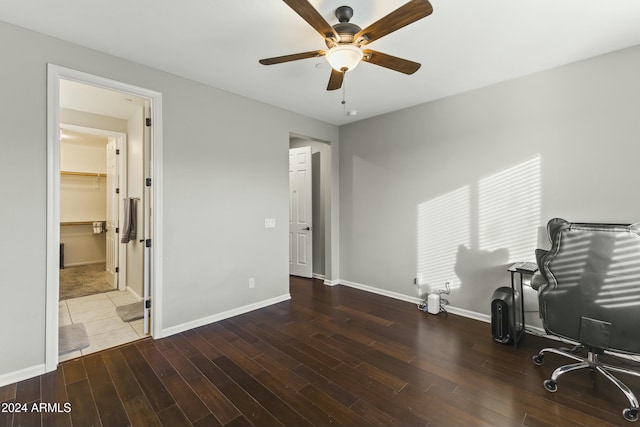 unfurnished office featuring ceiling fan and dark hardwood / wood-style flooring