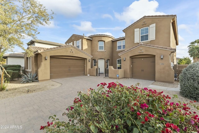 14575 W Orange Dr, Litchfield Park, AZ 85340 - mediterranean / spanish-style house with stucco siding, decorative driveway, a tile roof, and an attached garage