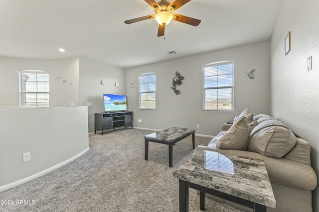 living room with ceiling fan, light colored carpet, and a wealth of natural light