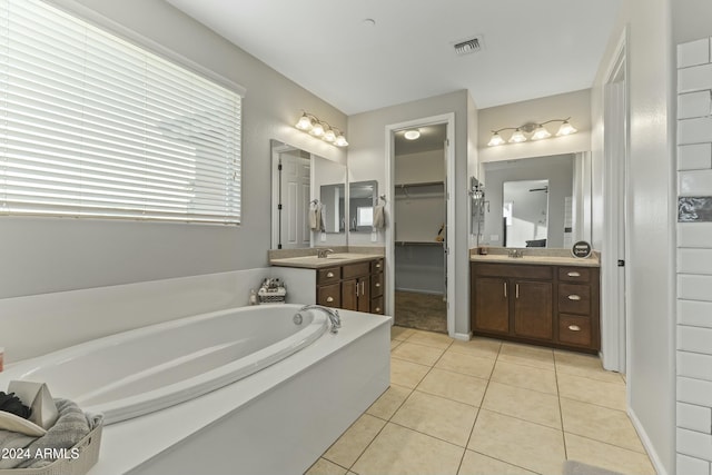 bathroom featuring a bath, vanity, and tile patterned floors