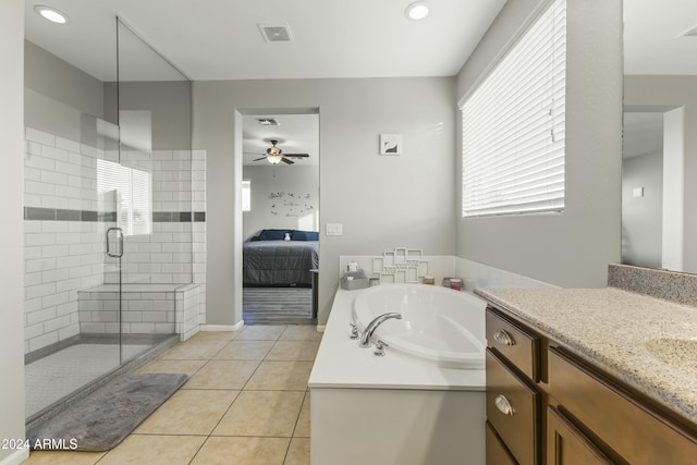 bathroom featuring vanity, ceiling fan, tile patterned flooring, and plus walk in shower