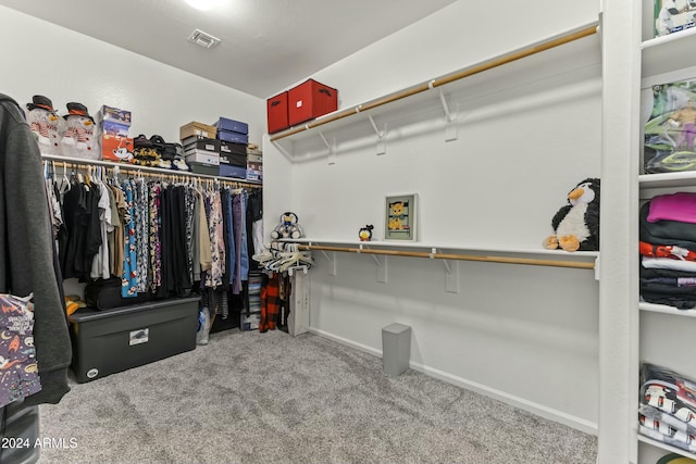 walk in closet with carpet flooring