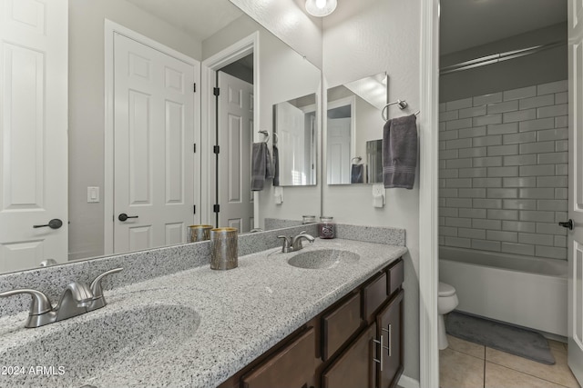 full bathroom featuring tiled shower / bath, tile patterned flooring, vanity, and toilet