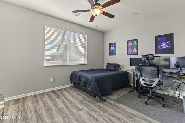 bedroom with hardwood / wood-style flooring and ceiling fan