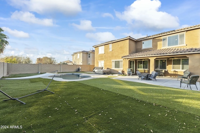 14575 W Orange Dr, Litchfield Park, AZ 85340 - rear view of house featuring a fenced backyard, stucco siding, a tiled roof, and a patio