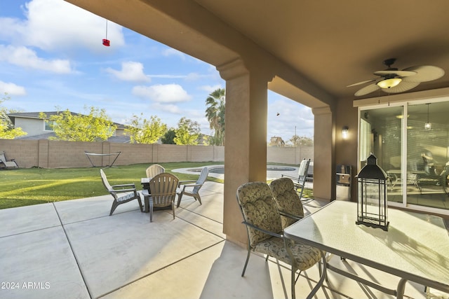 view of patio / terrace with a fenced in pool and ceiling fan