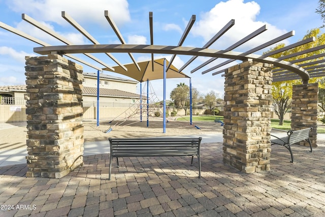 view of property's community featuring a playground and a pergola