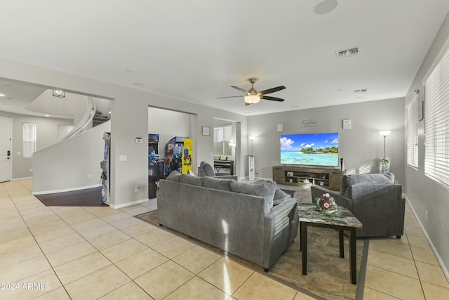 tiled living room featuring ceiling fan