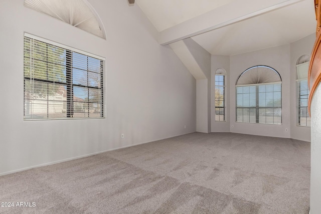 interior space featuring beam ceiling and high vaulted ceiling