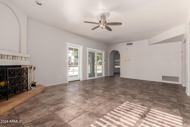 unfurnished living room with ceiling fan