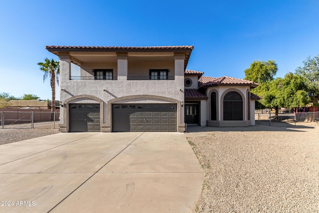 mediterranean / spanish-style home featuring a balcony and a garage