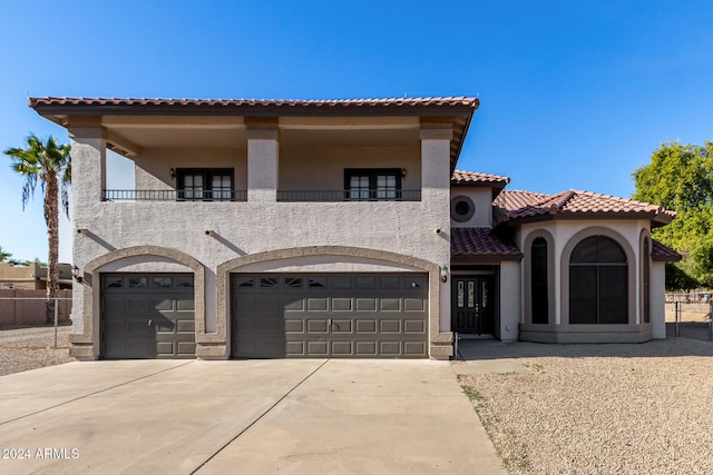 mediterranean / spanish home featuring a garage