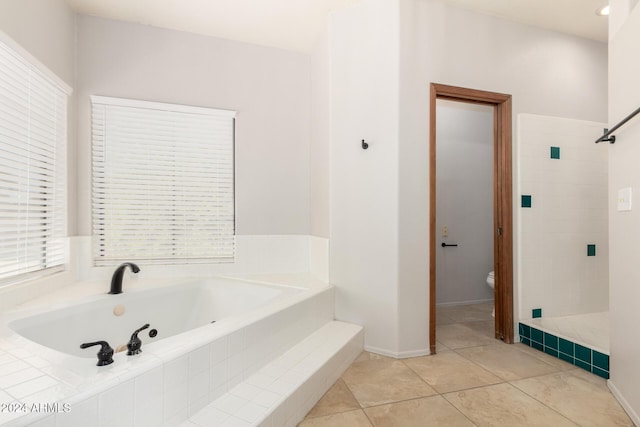 bathroom featuring tile patterned floors, toilet, and shower with separate bathtub