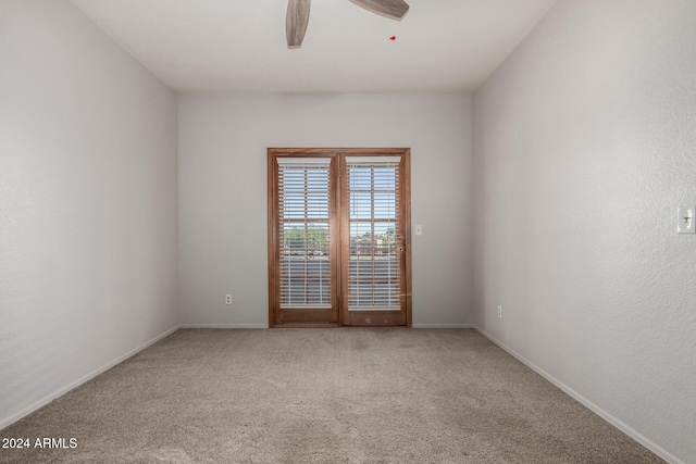 carpeted empty room with ceiling fan