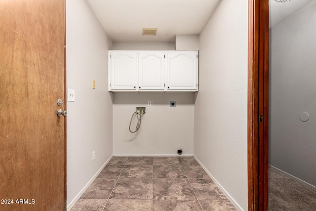 washroom with electric dryer hookup, hookup for a washing machine, and cabinets