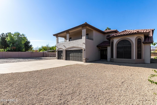 mediterranean / spanish house featuring a garage