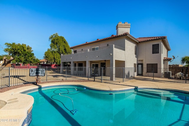 view of pool with a patio area and central AC unit