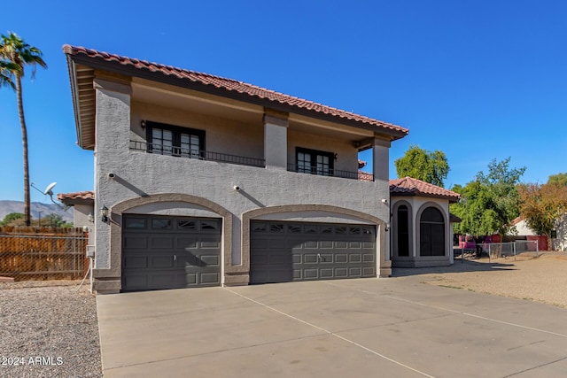 mediterranean / spanish-style home with a garage