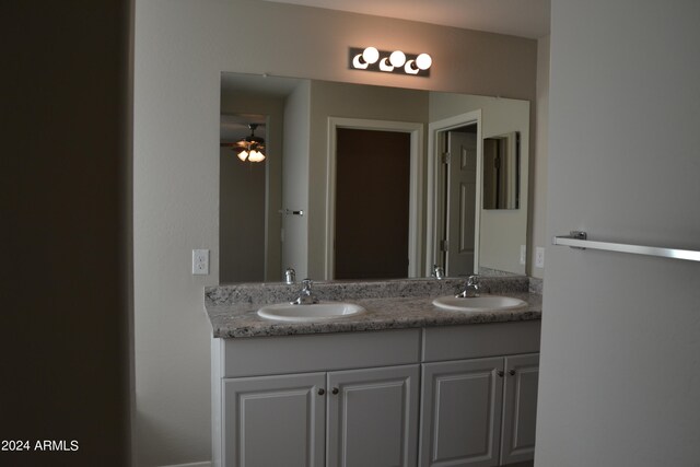 bathroom featuring ceiling fan and double sink vanity