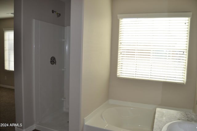 bathroom featuring separate shower and tub