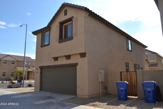 view of side of property with a garage