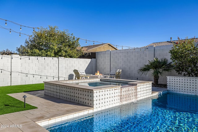 view of swimming pool featuring an in ground hot tub