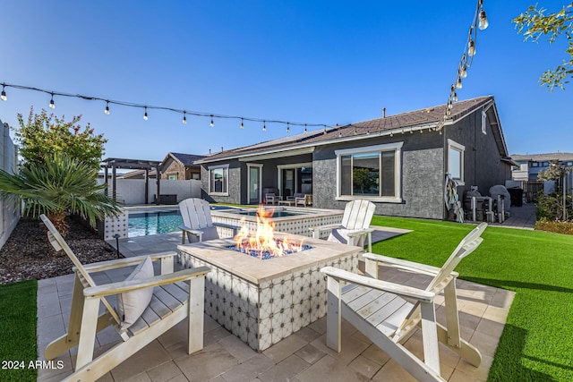 view of patio / terrace featuring a fenced in pool and an outdoor fire pit