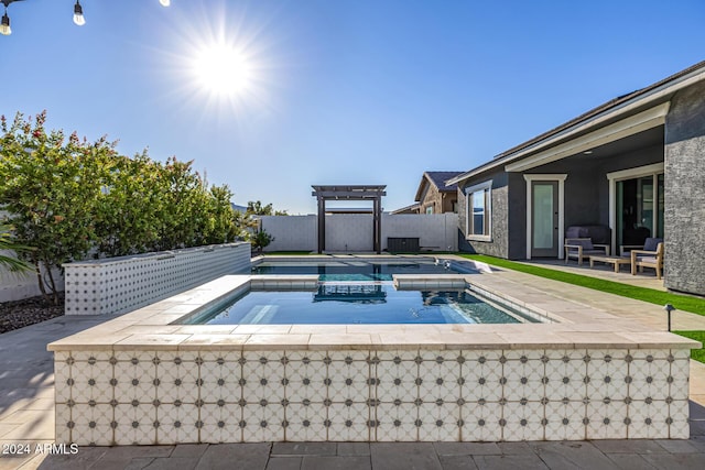 view of swimming pool featuring an in ground hot tub and a patio