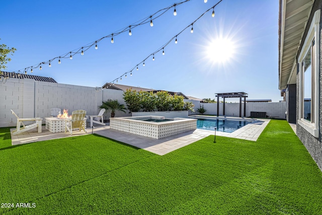 view of yard with a swimming pool with hot tub and a fire pit