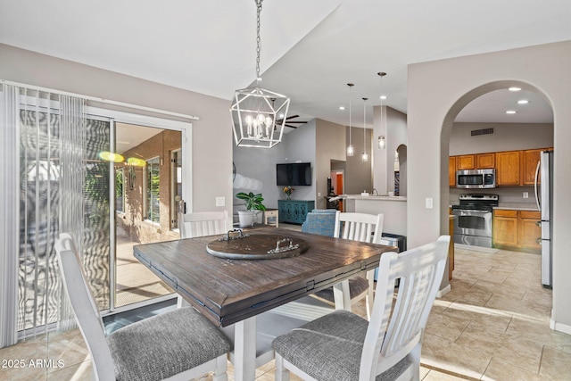 dining room featuring lofted ceiling and a chandelier