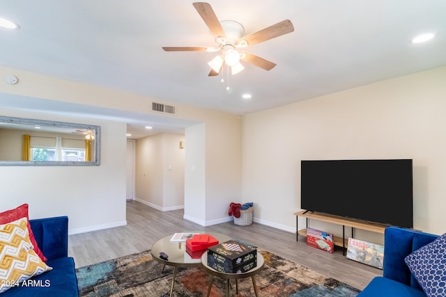 living room featuring wood-type flooring and ceiling fan