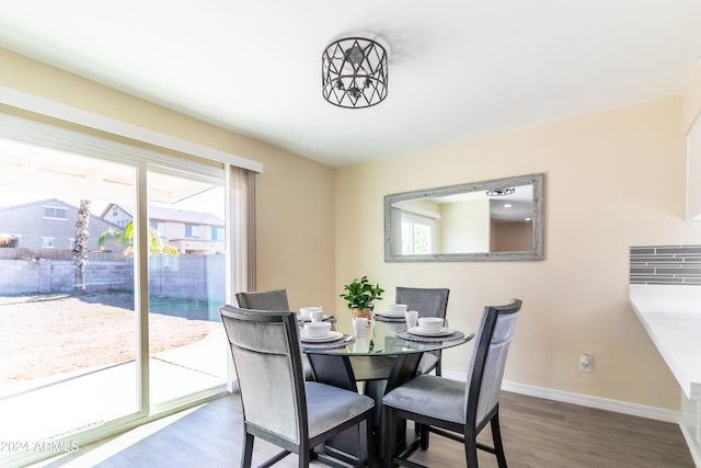 dining space with wood-type flooring